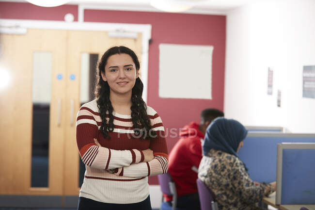 Portrait confident young female college student in library — Stock Photo