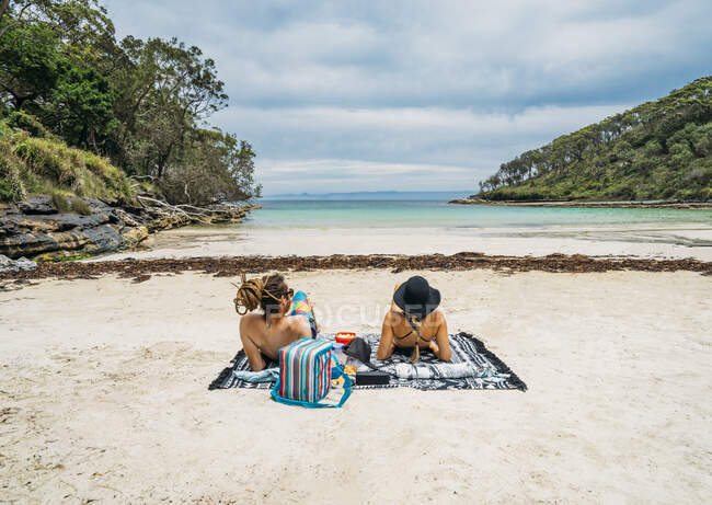 Paar sonnt sich am abgelegenen tropischen Ozeanstrand Jervis Bay Australien — Stockfoto