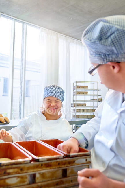 Happy young woman with Down Syndrome baking in kitchen — Stock Photo