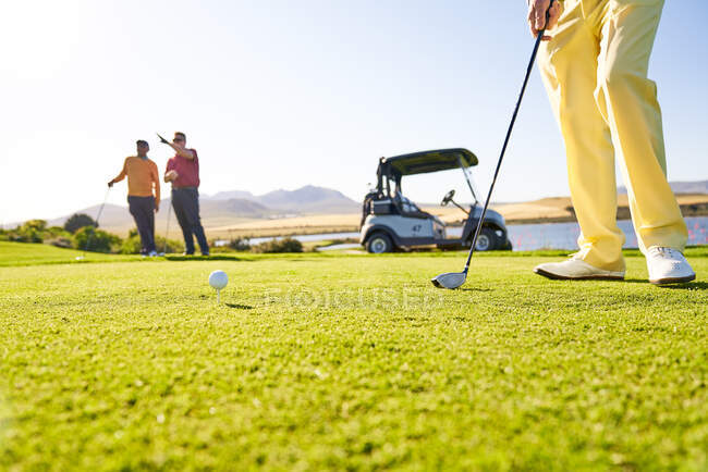 Golfista se preparando para tee off na caixa de tee ensolarado — Fotografia de Stock