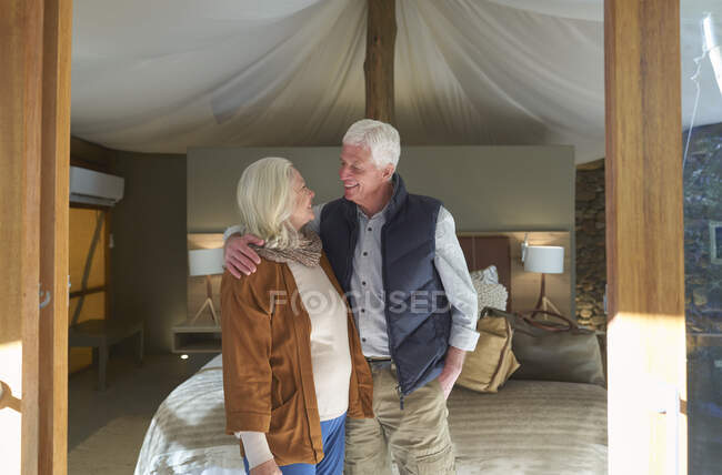 Happy senior couple in safari lodge hotel room — Stock Photo