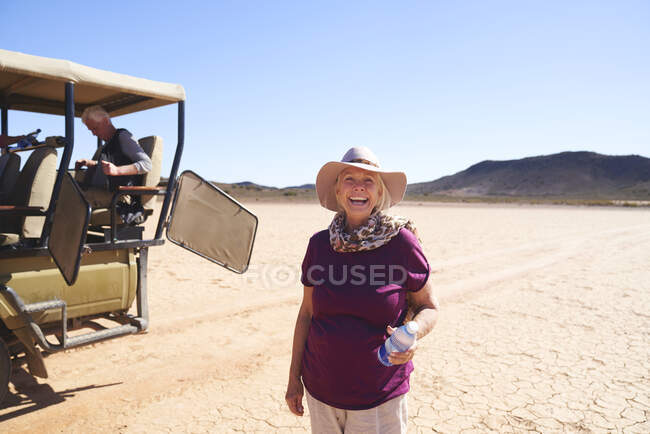 Portrait carefree senior woman on safari in sunny desert South Africa — Stock Photo