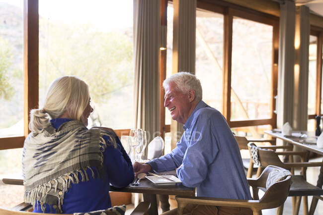 Happy senior couple dining in restaurant — Stock Photo