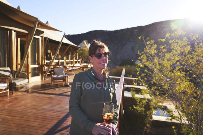 Portrait confident mature woman on sunny hotel balcony — Stock Photo