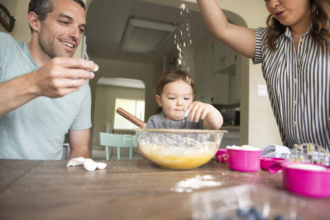 Happy young family baking — Stock Photo