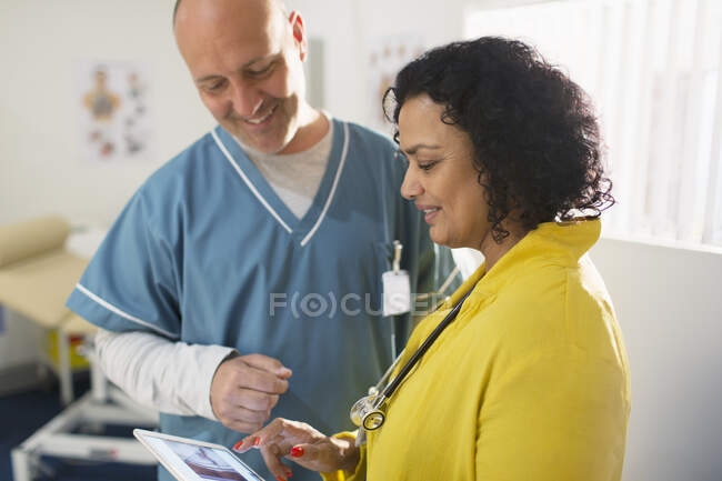 Doctors consulting, looking at digital x-ray — Stock Photo