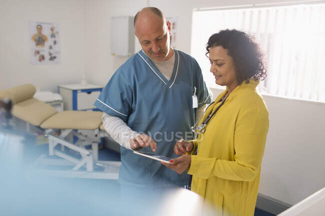 Médecins utilisant une tablette numérique dans le bureau des médecins — Photo de stock