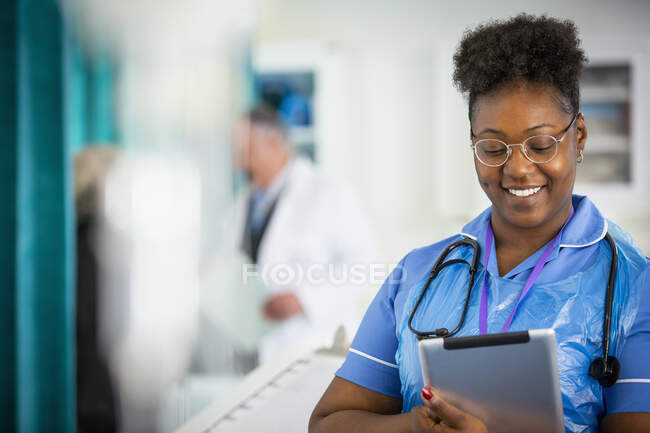 Female nurse using digital tablet in hospital — Stock Photo