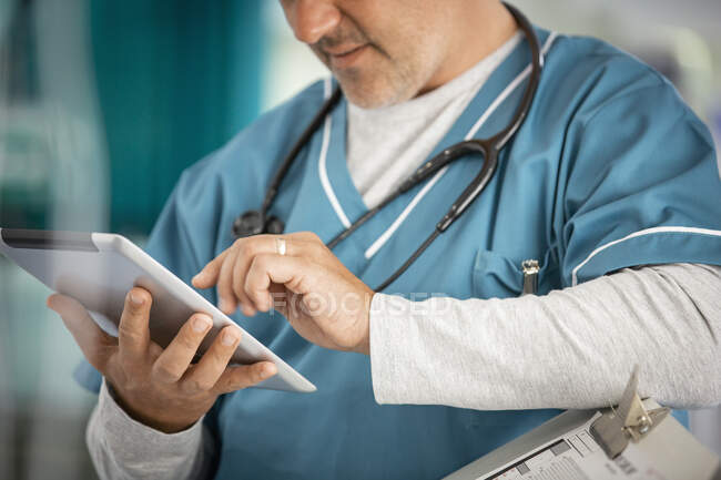 Male doctor using digital tablet — Stock Photo