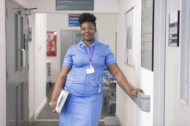 Portrait confident female nurse in hospital corridor — Stock Photo