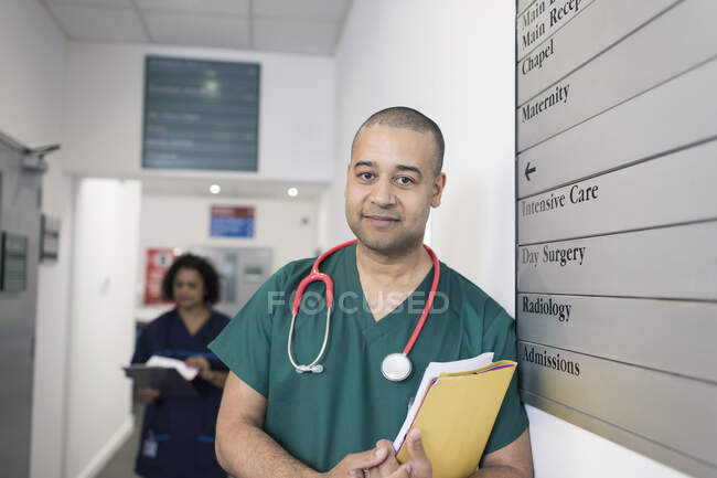 Portrait confiant chirurgien masculin confiant dans le couloir de l'hôpital — Photo de stock
