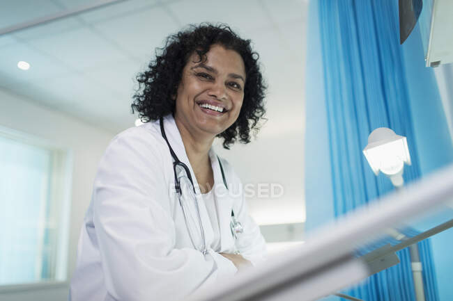 Portrait confident, smiling female doctor in hospital room — Stock Photo
