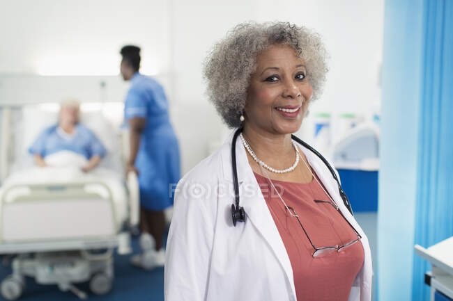 Portrait confident senior female doctor in hospital room — Stock Photo