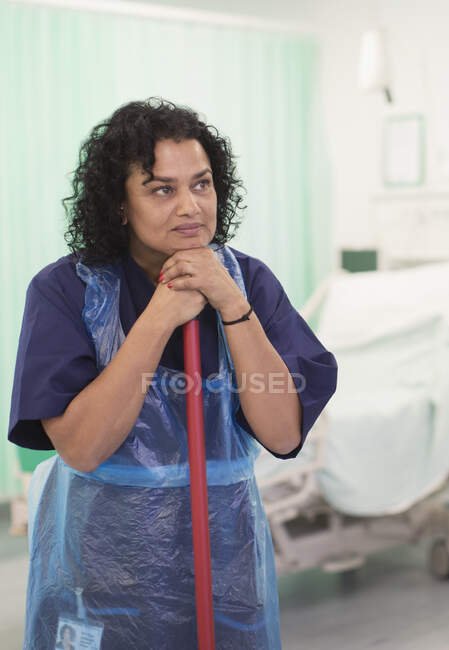 Thoughtful female orderly cleaning hospital ward — Stock Photo