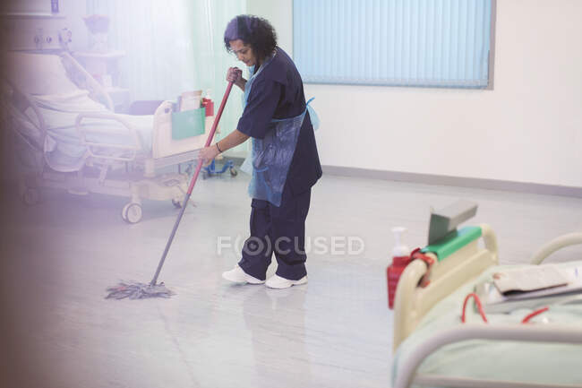 Female orderly mopping hospital ward floor — Stock Photo