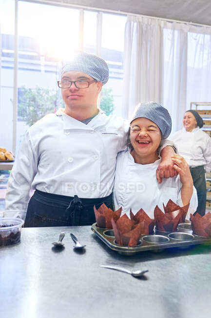 Happy young friends with Down Syndrome in sunny cafe — Stock Photo