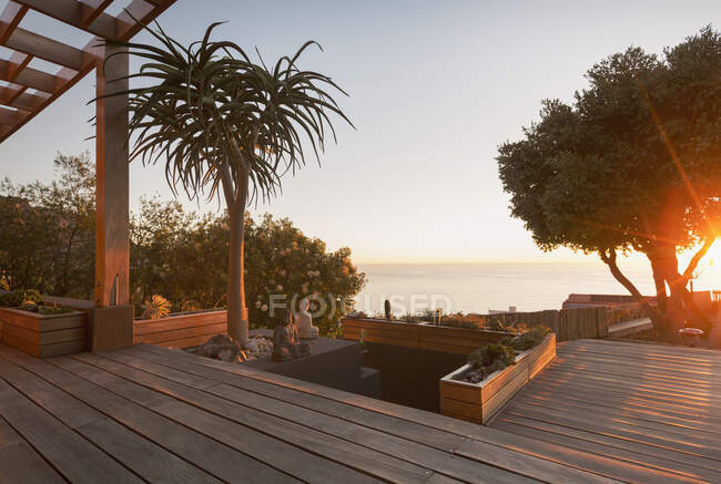 Ruhige moderne, luxuriöse Wohnung Vitrine außen Holzdeck mit Sonnenuntergang Meerblick — Stockfoto