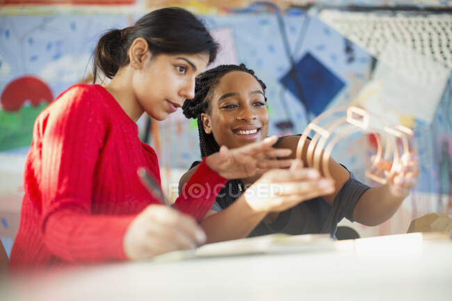 Female engineers examining prototype in office — Stock Photo