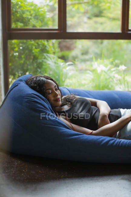 Serene young woman relaxing listening to music with headphones — Stock Photo
