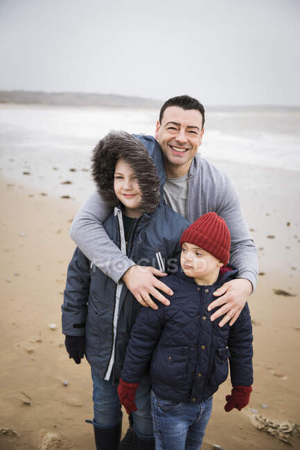 Portrait happy Down Syndrome family on beach — Stock Photo