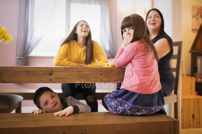Portrait happy Down Syndrome family in dining room — Stock Photo