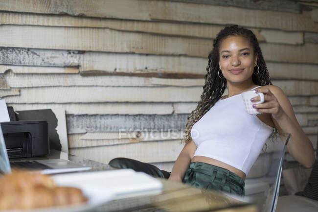 Portrait confident young female entrepreneur working in home office — Stock Photo