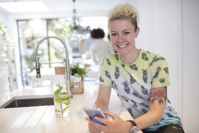 Retrato mulher confiante com tatuagem usando telefone inteligente — Fotografia de Stock