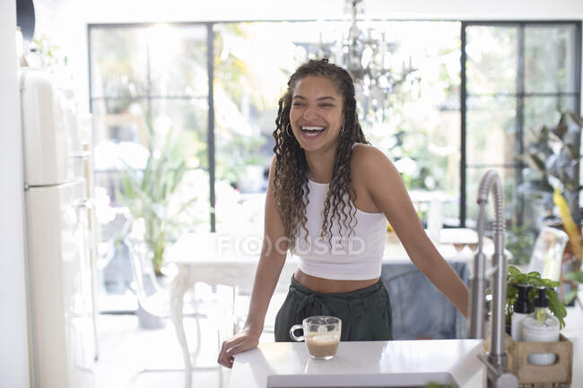 Щаслива молода жінка сміється на кухні — стокове фото