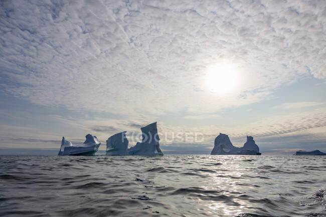 Des icebergs majestueux sous un ciel ensoleillé sur l'océan Atlantique Groenland — Photo de stock