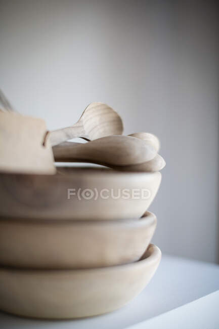 Stacked wooden bowls and spoons — Stock Photo