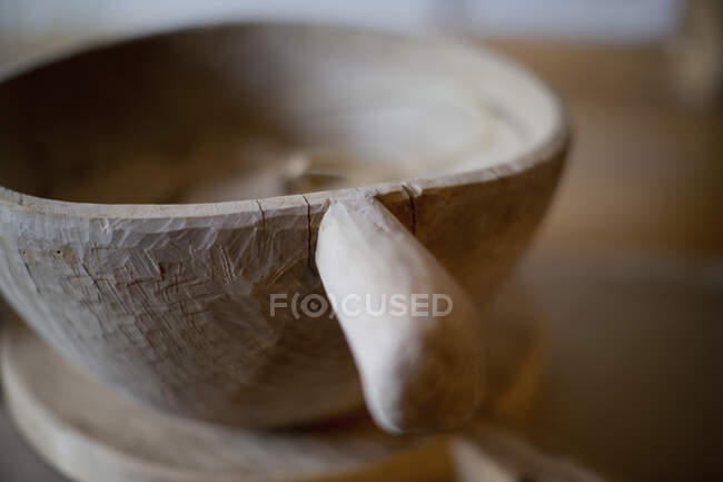 Close up rustic wooden bowl with handle — Stock Photo