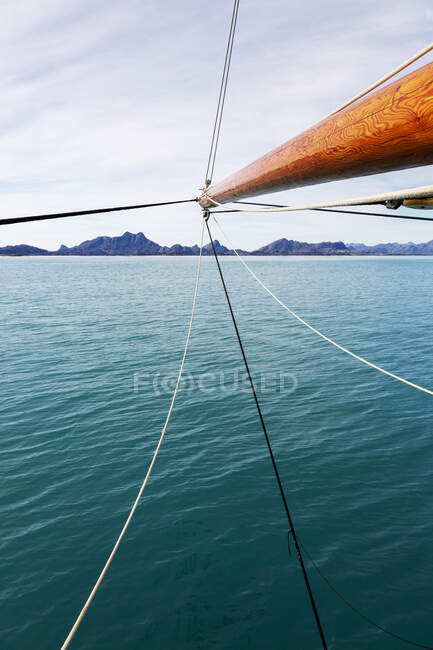 Sailboat mast over sunny blue Atlantic Ocean — Stock Photo