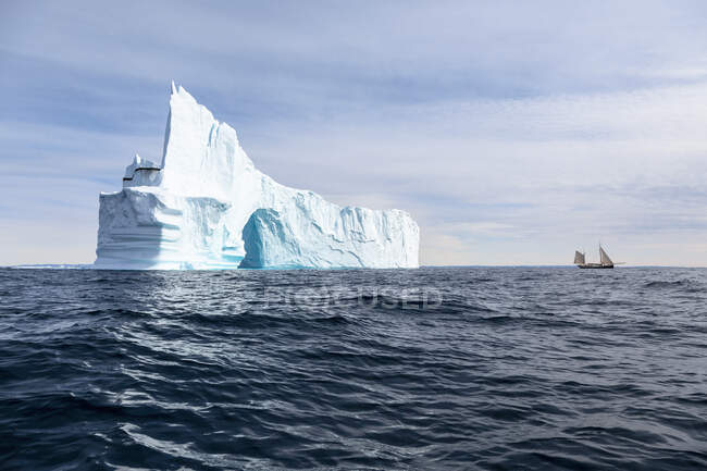 Majestoso arco de iceberg sobre azul tranquilo ensolarado Oceano Atlântico Groenlândia — Fotografia de Stock