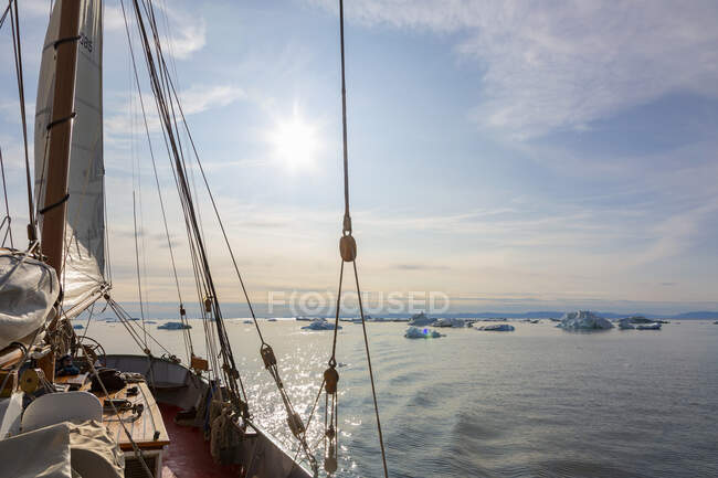Navio que navega perto de derreter icebergs em ensolarado tranquilo Oceano Atlântico Groenlândia — Fotografia de Stock