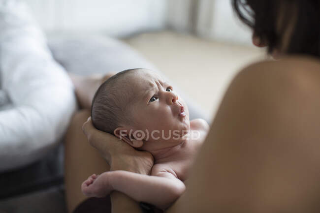 Mother holding cute fussy newborn baby boy — Stock Photo