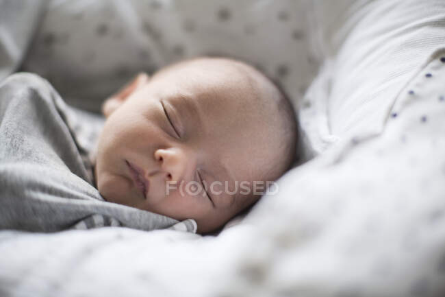 Close up tired newborn baby boy sleeping — Stock Photo