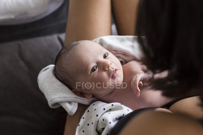 Mother cradling cute newborn baby son — Stock Photo