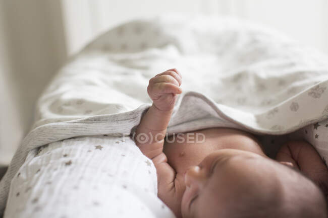 Close up newborn baby boy laying in bassinet — Stock Photo