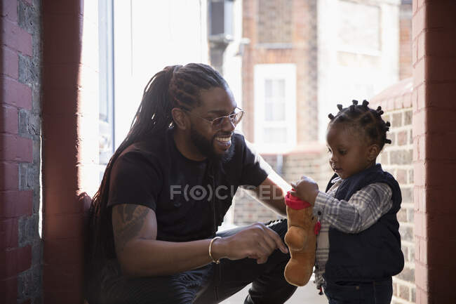 Father and toddler son playing with stuffed animal — Stock Photo