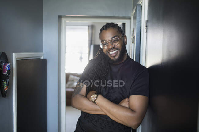 Portrait confident handsome man with long braids in corridor — Stock Photo