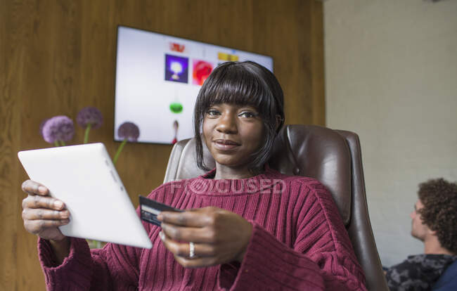 Ritratto giovane donna shopping online con tablet digitale e carta di credito — Foto stock