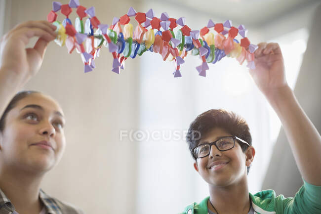 Students examining DNA model in classroom laboratory — Stock Photo