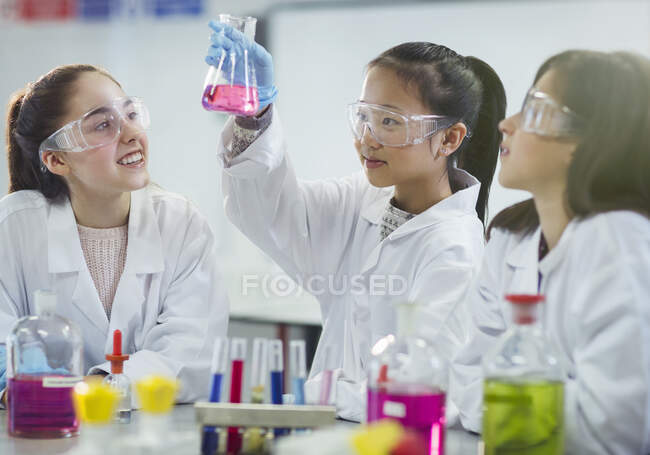 Chicas estudiantes realizando experimentos científicos en el aula de química de laboratorio - foto de stock