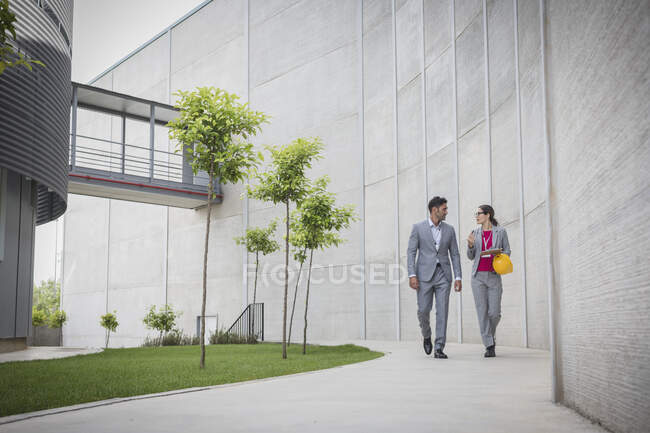 Supervisors walking on sidewalk outside factory — Stock Photo