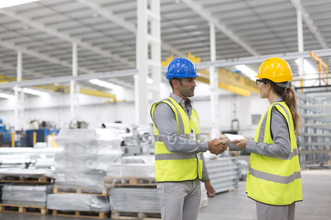 Supervisors handshaking in warehouse — Stock Photo