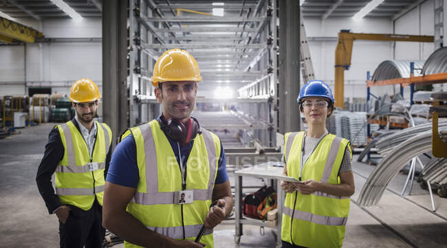 Portrait confident supervisors and worker in steel factory — Stock Photo