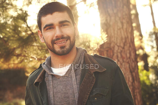 Portrait confident young man in woods — Stock Photo
