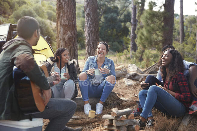 Young friends laughing, hanging out at campsite — Stock Photo