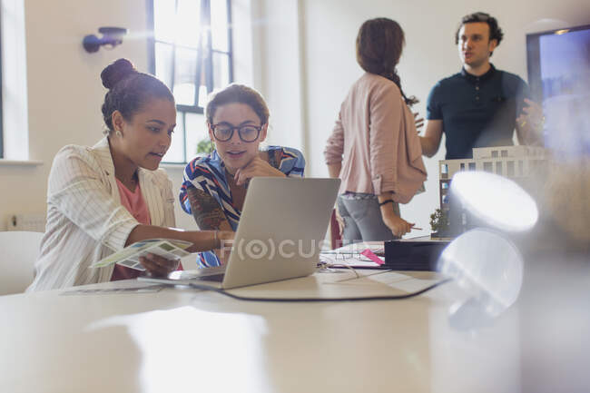 Female architects using laptop in conference room meeting — Stock Photo