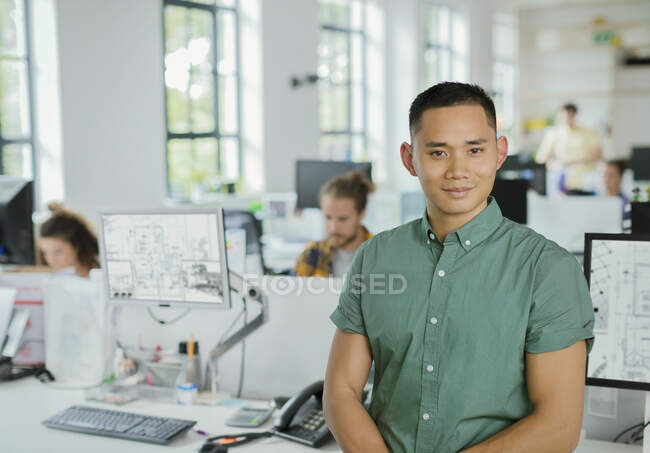 Retrato confiante arquiteto masculino em plano aberto escritório — Fotografia de Stock